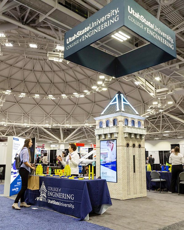 A replica of Old Main tower from USU in an expo center.