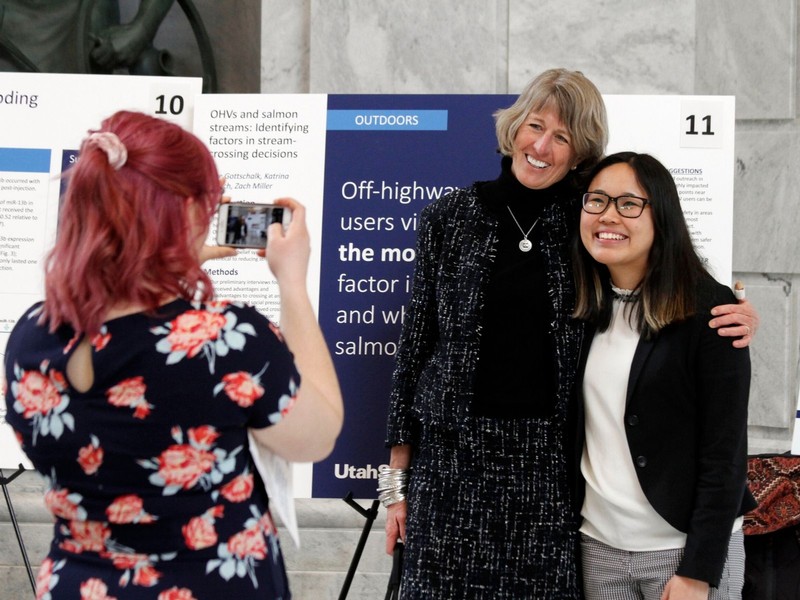 USU President Noelle Cockett Poses for a photo with a student researcher at the Utah State Capitol.