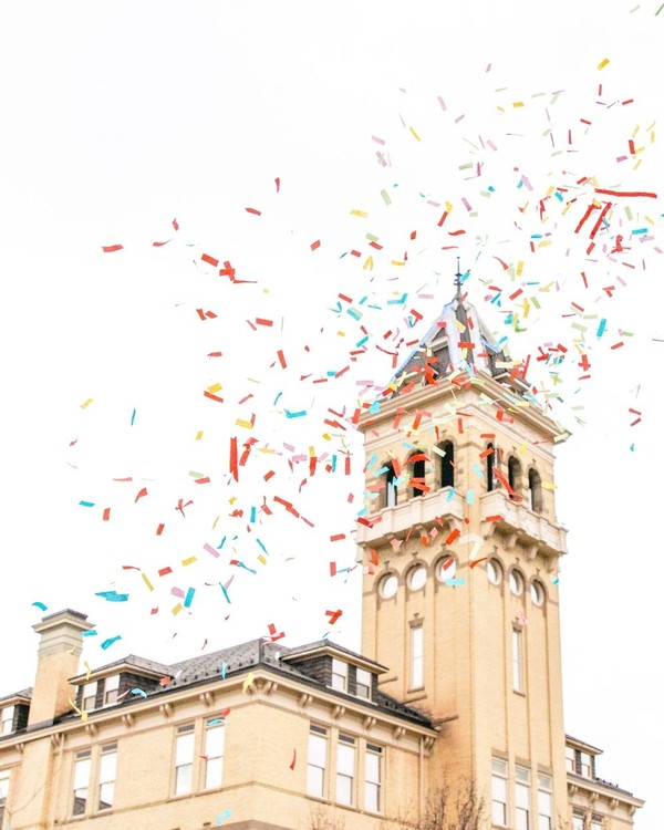 Confetti blasts through the air in front of Old Main