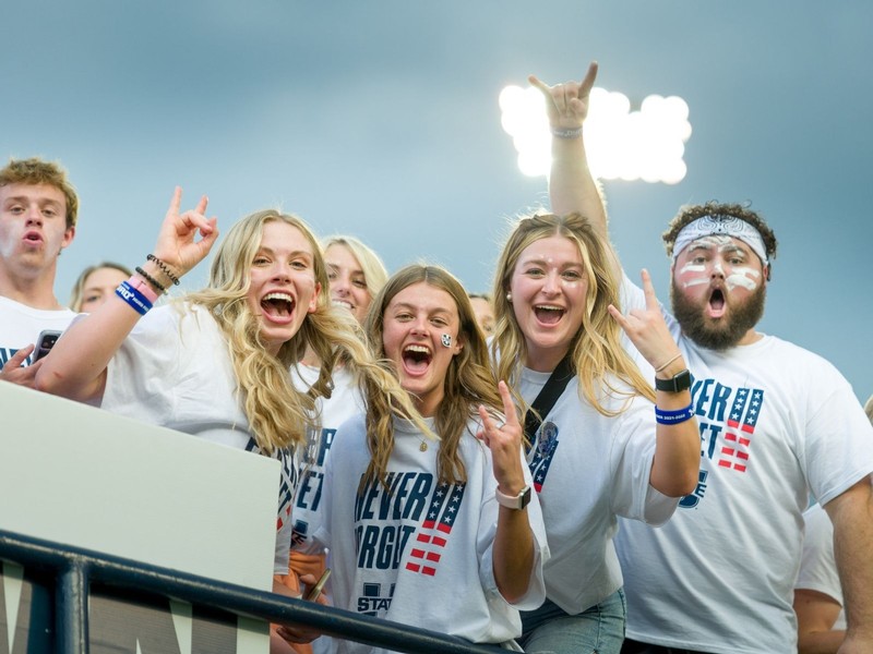 USU students cheer from the stands inside Maverik Stadium