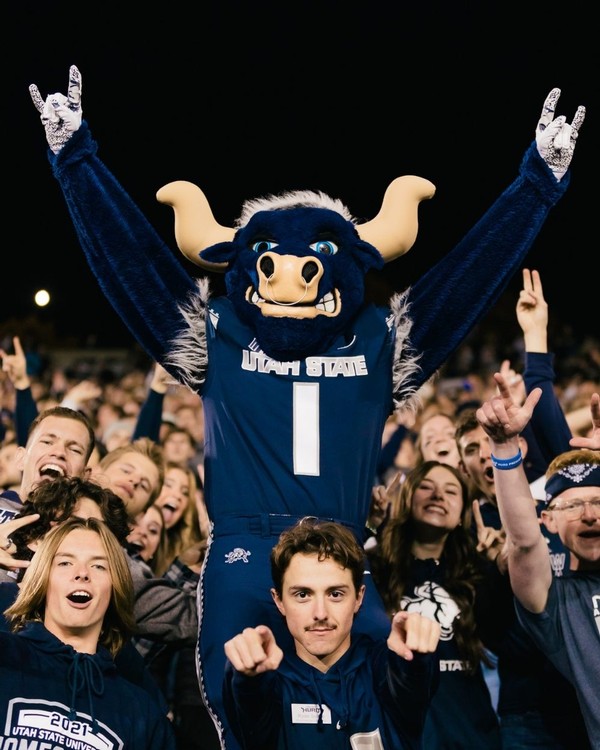 USU students cheer with Big Blue from the stands inside Maverik Stadium