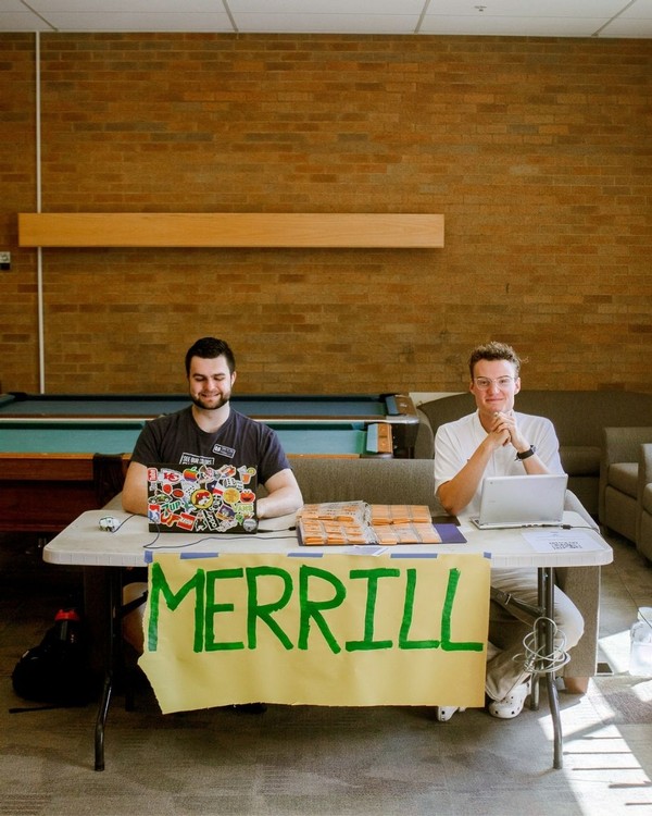 Two male students sit at a table.