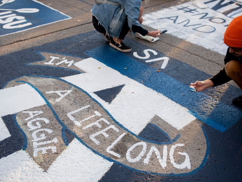 Students painting the Block 'A' in the street to celebrate USU's Homecoming.