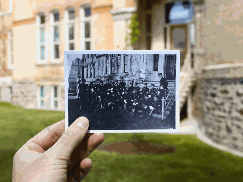 Members of USU's ROTC (circa 1920) sitting on the steps leading to the south wing of Old Main.