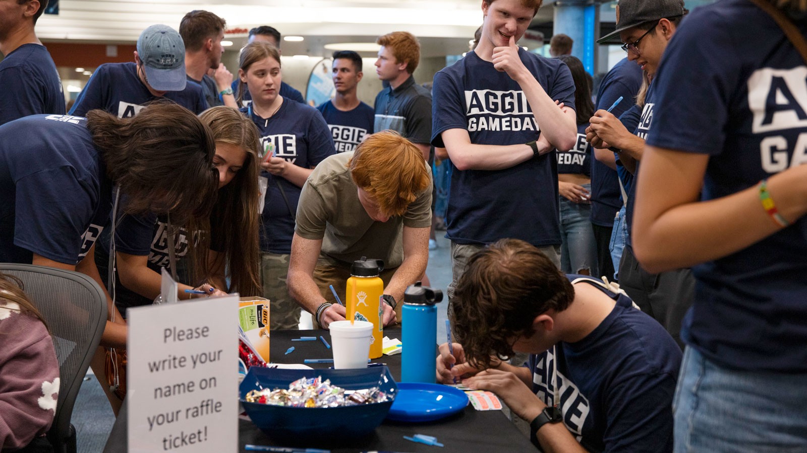 Students socialize in the Merrill-Cazier Library during an event.