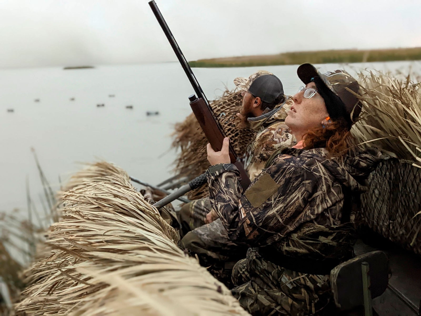 Two people hunting ducks.