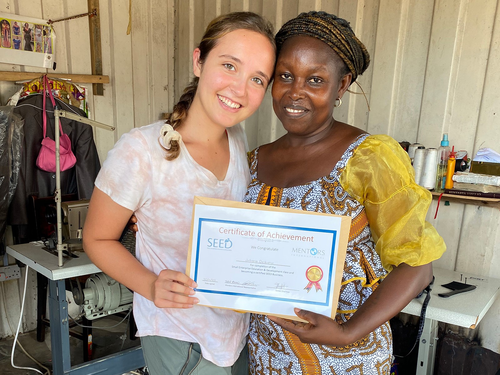 Two women pose with a certificate